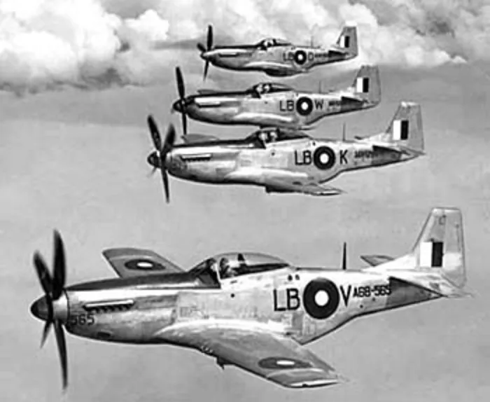 Flying from Townsville, Qld. 1945-07-27. Four P-51 Mustang aircraft of No. 84 Squadron RAAF, newest fighter to be flown by Australians in this theatre of war, flying in echelon right, up formation. Pilots and aircraft, front to rear: 290898 Squadron Leader J. A. Cox* of Mt Lawley, WA, in aircraft A68-565, coded LB-V a North American P-51K-10-NT; 404355 Flight Lieutenant R. G. Riddel of Galloway Hill, Qld, in aircraft A68-529 coded LB-K; 402530 Flight Lieutenant D. N. McQueen of Grafton, NSW, in aircraft A68-526 coded LB-W; 411111 Flight Lieutenant S. E. Armstrong of Charleville, Qld.